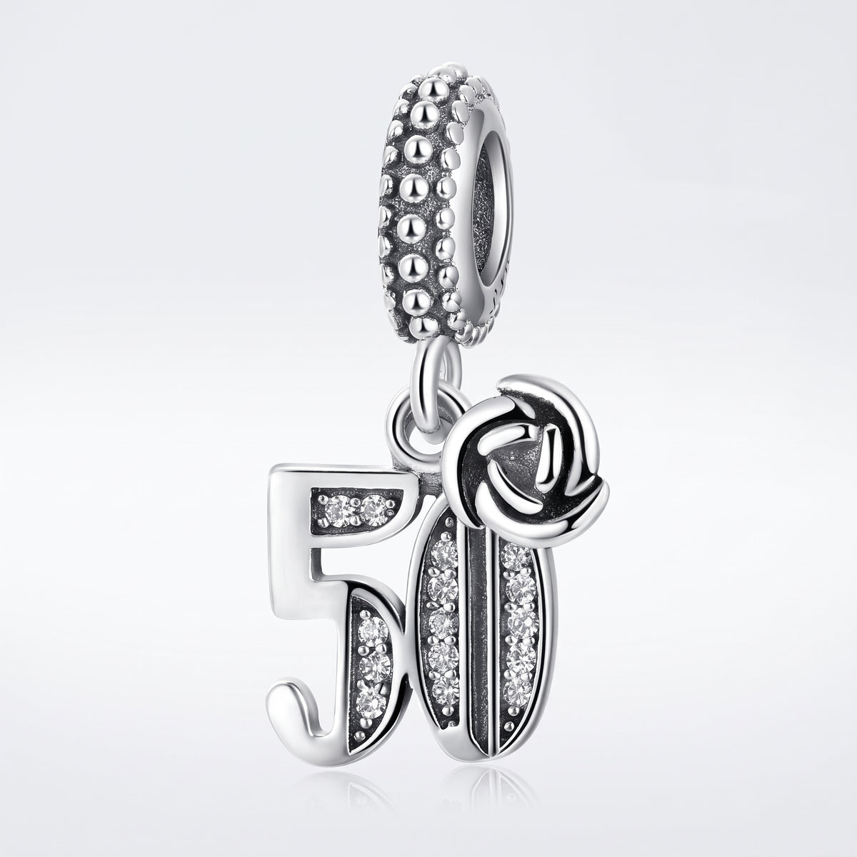 A silver 50th birthday charm featuring the number 51 with clear crystal accents and a rose motif, shown on a light gray reflective background.